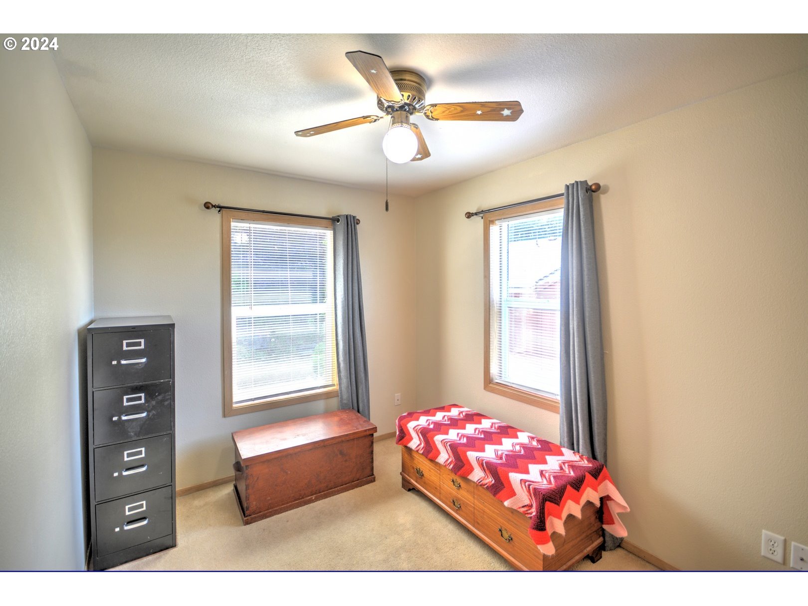 421 Elk Creek Road Cannon Beach, OR 97110 - Photo 12 of 16 a bedroom with furniture and a window