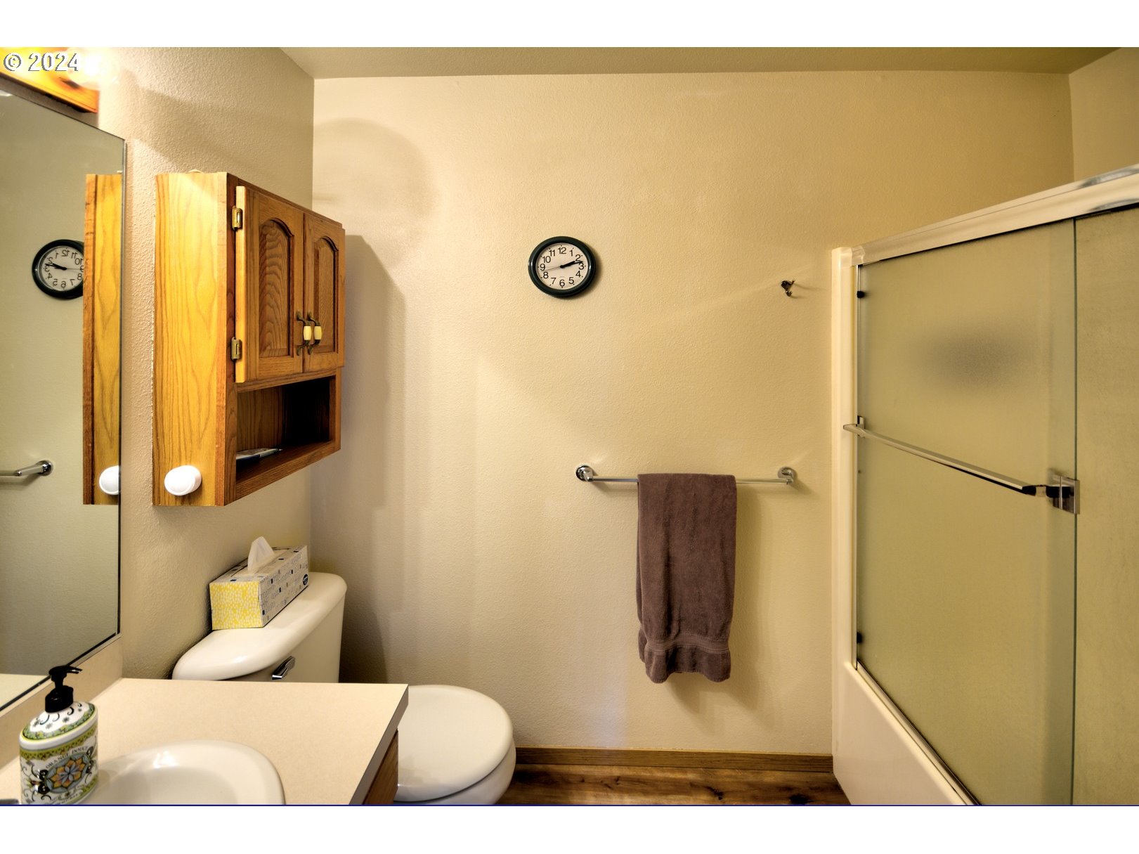 421 Elk Creek Road Cannon Beach, OR 97110 - Photo 13 of 16 a bathroom with a toilet sink and mirror