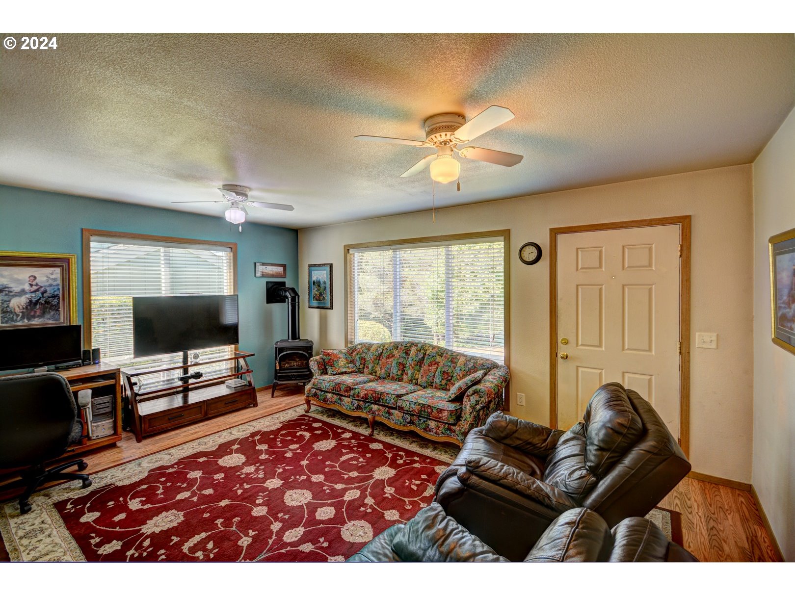 421 Elk Creek Road Cannon Beach, OR 97110 - Photo 3 of 16 a living room with furniture flat screen tv and a large window