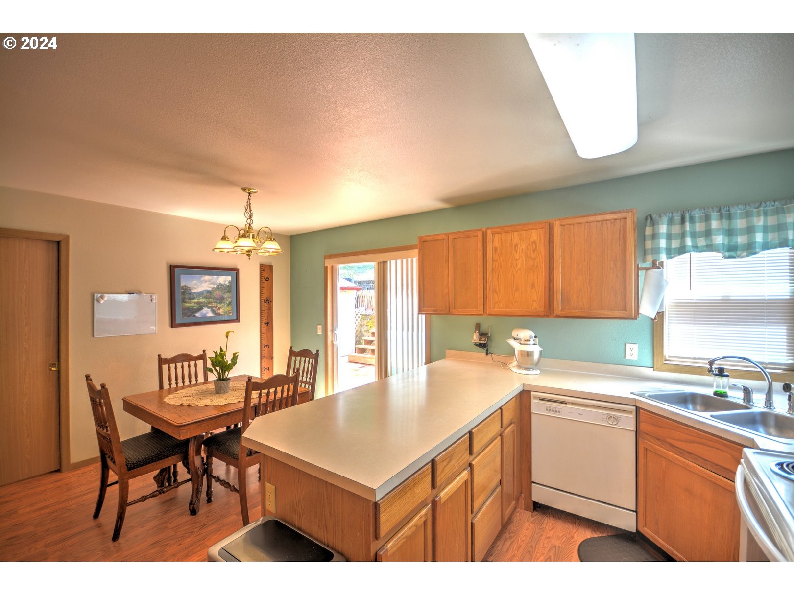 421 Elk Creek Road Cannon Beach, OR 97110 - Photo 7 of 16 a kitchen with a sink a counter top space and living room view
