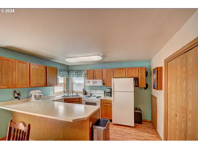 a kitchen with a sink a refrigerator and a stove