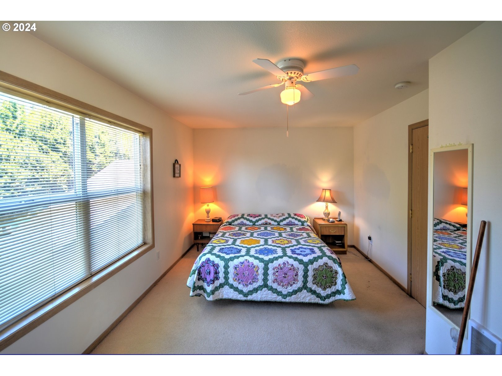421 Elk Creek Road Cannon Beach, OR 97110 - Photo 9 of 16 a bedroom with a bed and a window