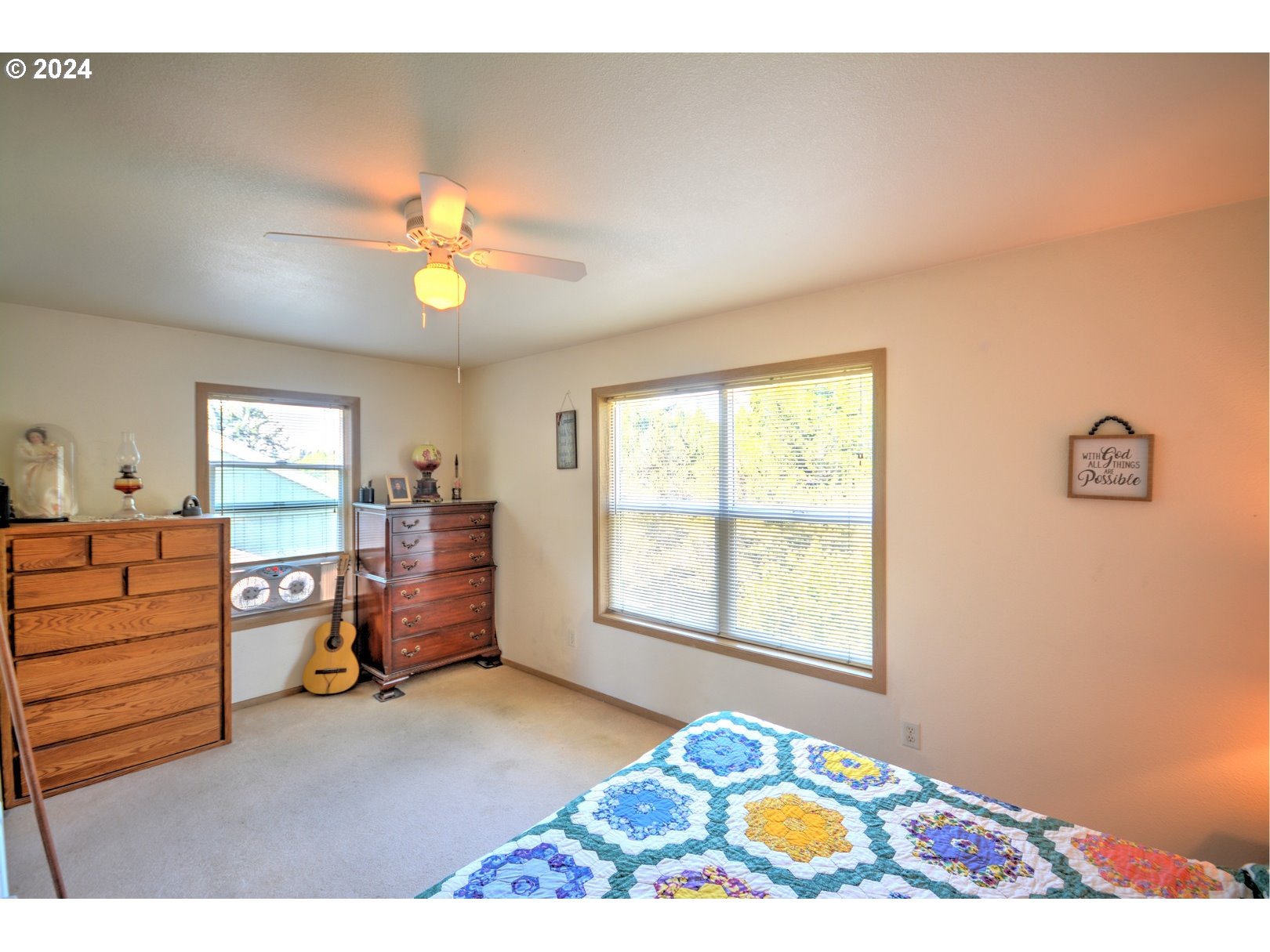 421 Elk Creek Road Cannon Beach, OR 97110 - Photo 10 of 16 a bedroom with a bed and a window