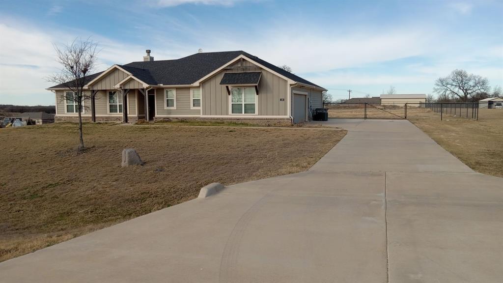 128 Spring Creek Circle Paradise, TX 76073 - Photo 1 of 21 a front view of a house with a yard