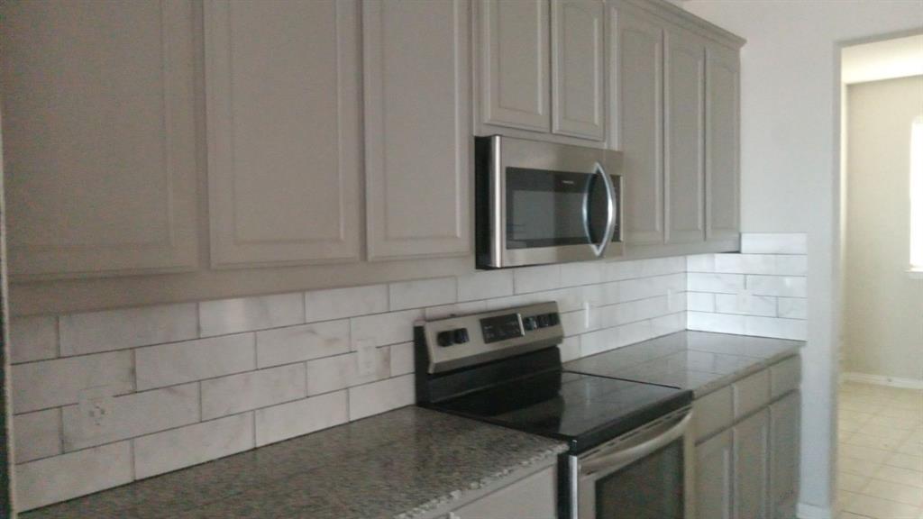 128 Spring Creek Circle Paradise, TX 76073 - Photo 11 of 21 a kitchen with granite countertop a sink and cabinets
