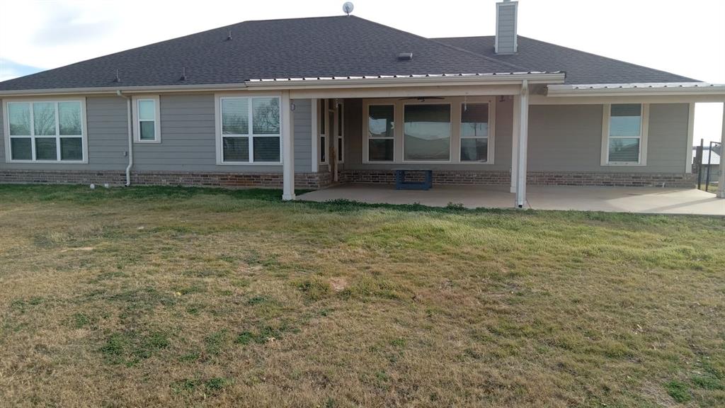 128 Spring Creek Circle Paradise, TX 76073 - Photo 4 of 21 a front view of a house with garden