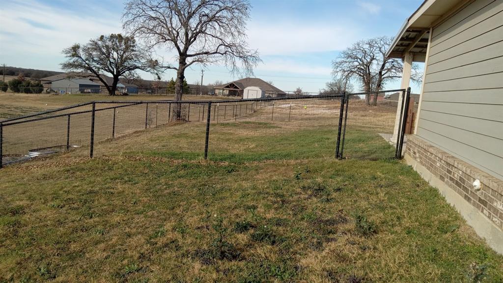 128 Spring Creek Circle Paradise, TX 76073 - Photo 8 of 21 a view of backyard with wooden fence