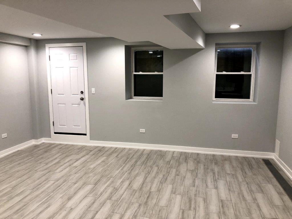 3210 South May Street, Unit B Chicago, IL 60608 - Photo 2 of 12 a view of an empty room with wooden floor and windows