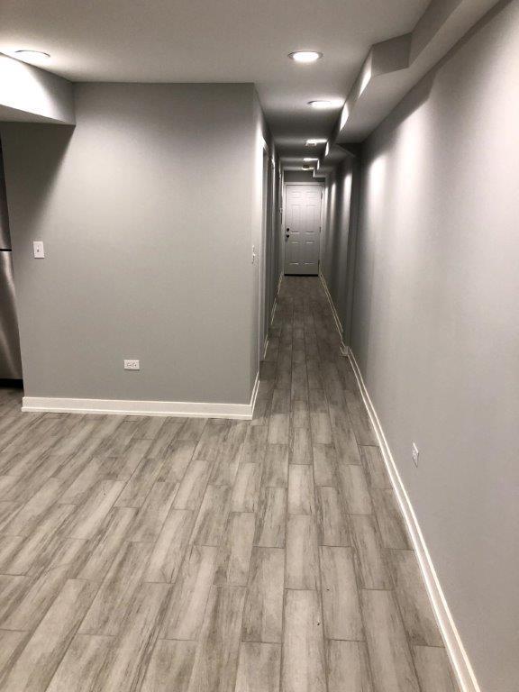 3210 South May Street, Unit B Chicago, IL 60608 - Photo 7 of 12 an empty room with wooden floor and windows