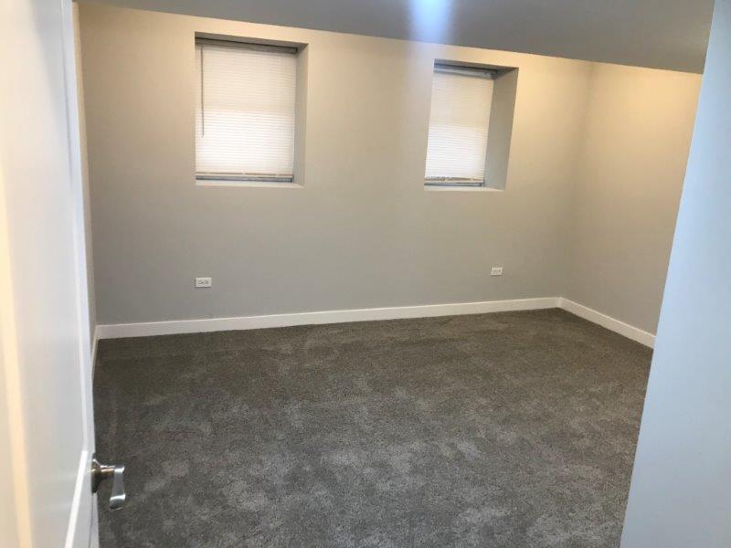 3210 South May Street, Unit B Chicago, IL 60608 - Photo 10 of 12 an empty room with a window