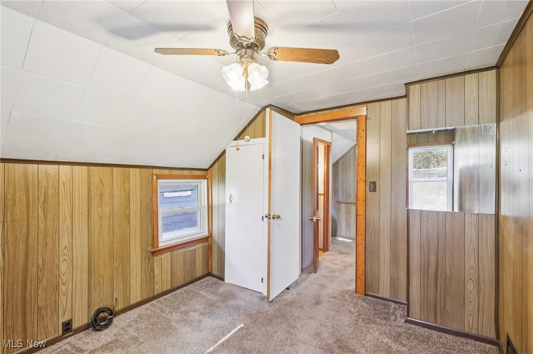 6235 Jefferson Road Ashtabula, OH 44004 - Photo 24 of 40 Additional living space featuring wooden walls, lofted ceiling, carpet floors, and ceiling fan