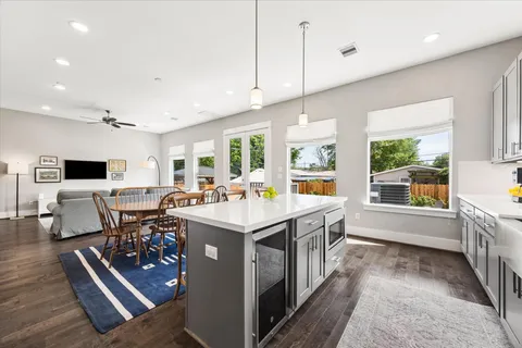 a kitchen with stainless steel appliances kitchen island granite countertop a sink and wooden cabinets