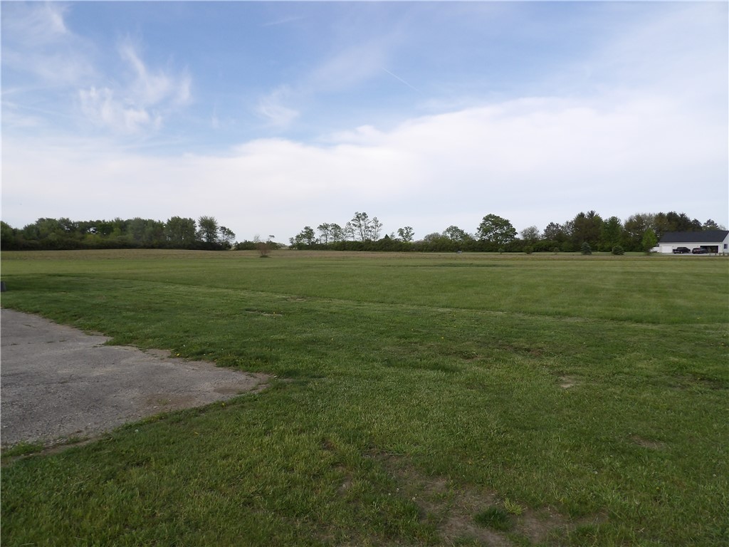 4505 North Alcony Conover Road Conover, OH 45317 - Photo 53 of 64 Expansive green lot with distant trees and a clear sky.