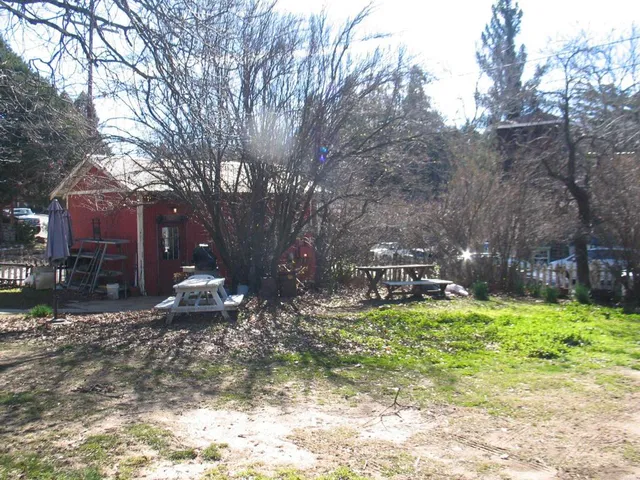 a view of a house with a yard covered in snow