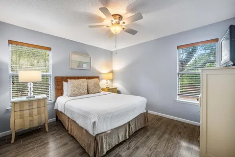 a bedroom with a large bed chandelier and a window
