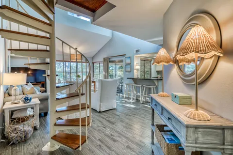 a living room with furniture a fireplace and a dining table with wooden floor