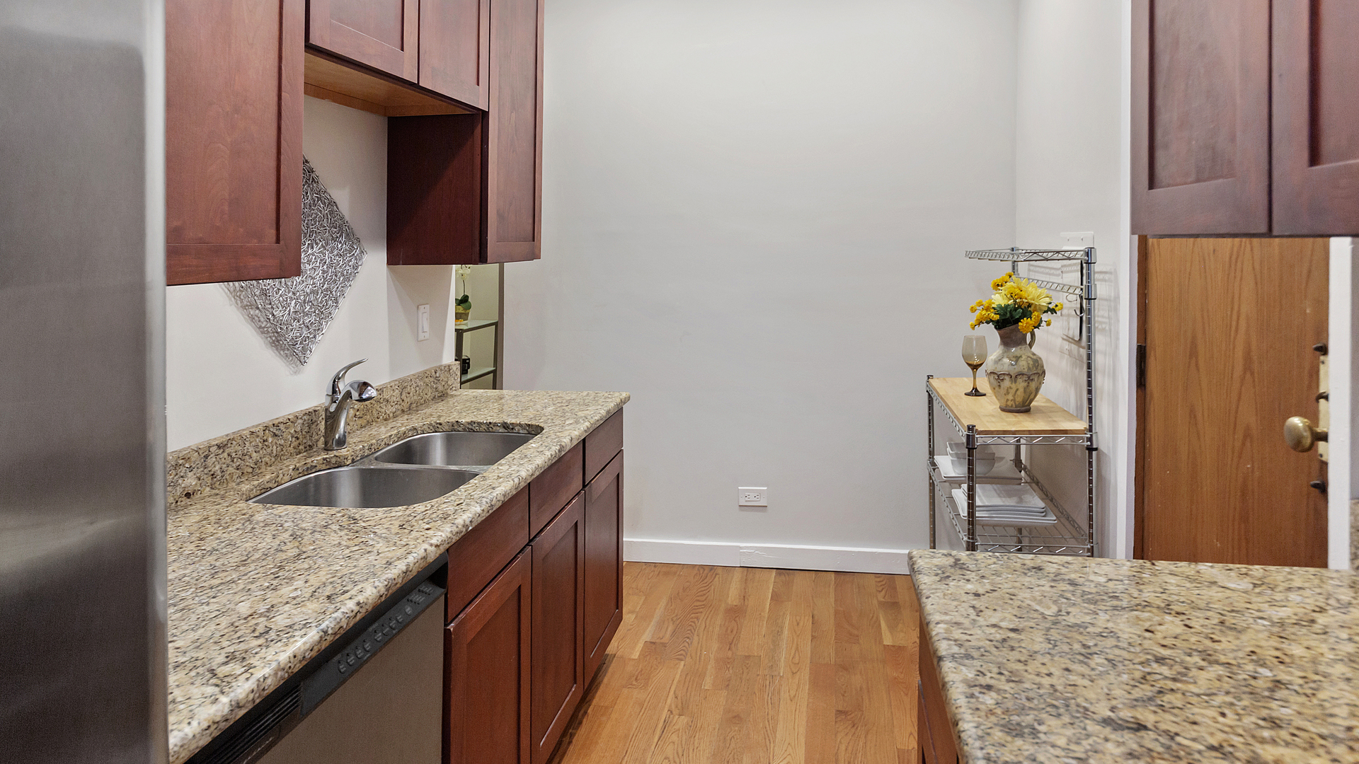 1321 West Addison Street, Unit 2A Chicago, IL 60613 - Photo 11 of 17 a kitchen with a sink and a refrigerator