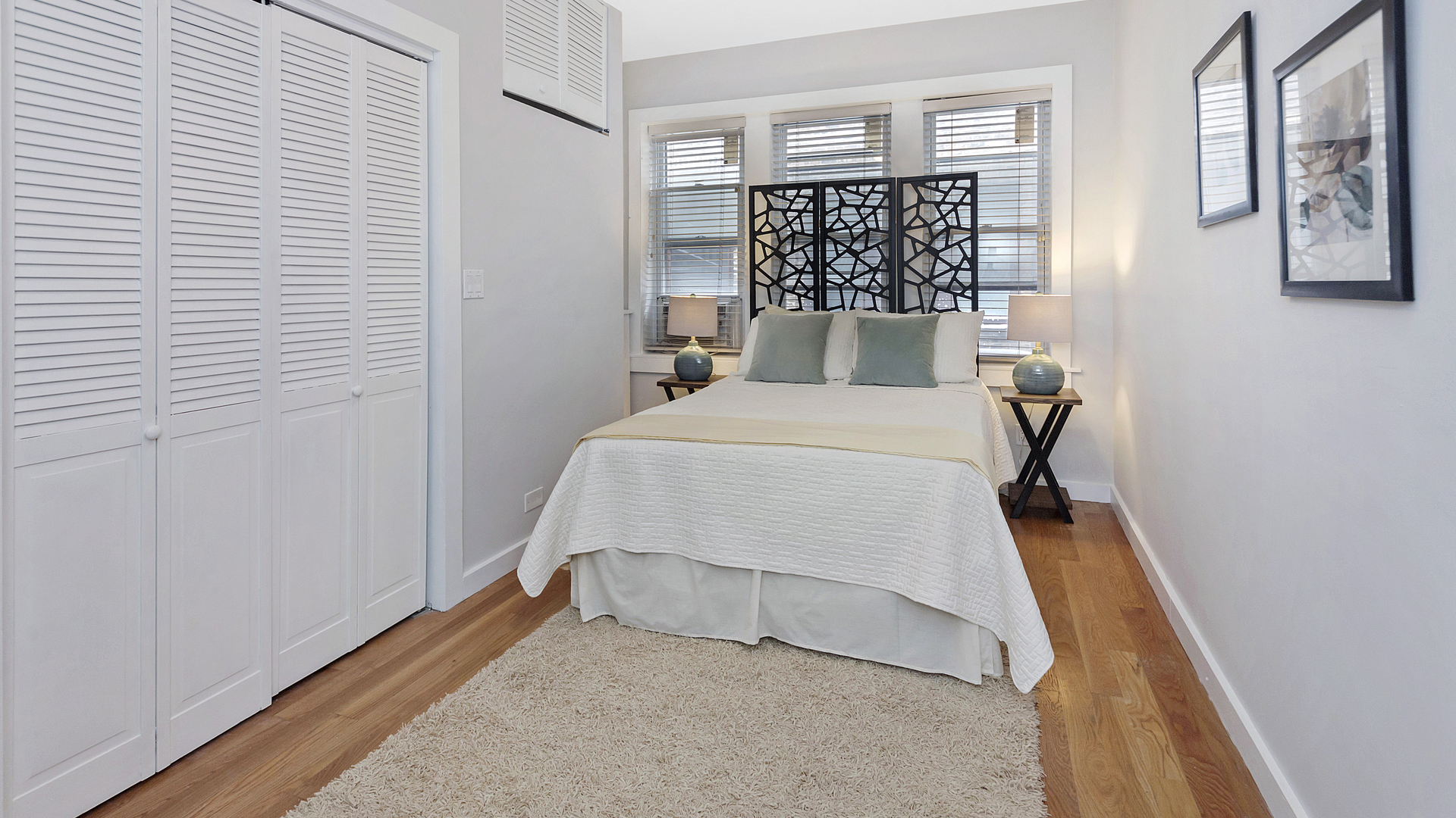 1321 West Addison Street, Unit 2A Chicago, IL 60613 - Photo 14 of 17 a bedroom with a bed and a wall painting