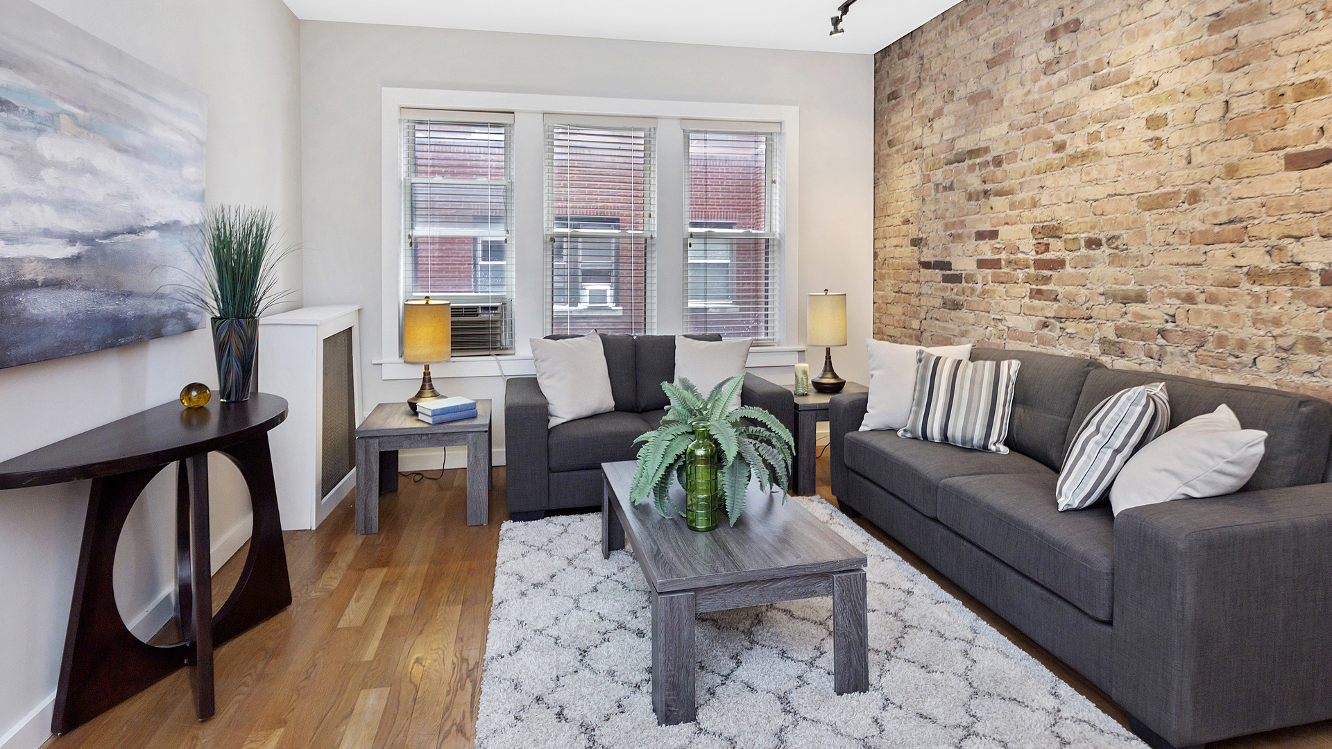 1321 West Addison Street, Unit 2A Chicago, IL 60613 - Photo 7 of 17 a living room with furniture and a potted plant