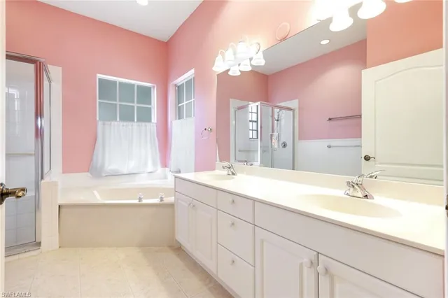 a bathroom with a tub a sink and mirror