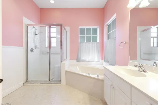a bathroom with a tub sink and mirror