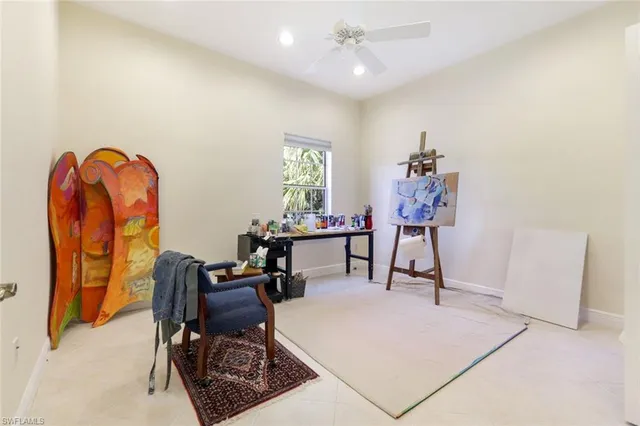 a living room with furniture a desk and chair