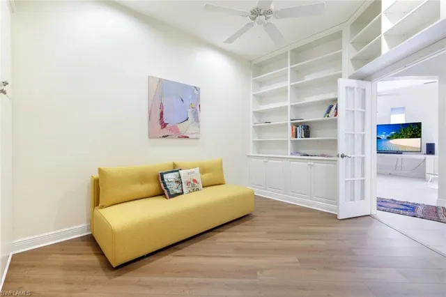 a living room with furniture and a view of kitchen