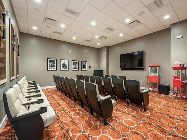 a living room with furniture a flat screen tv and a table