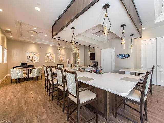 a view of a dining room with furniture and a chandelier