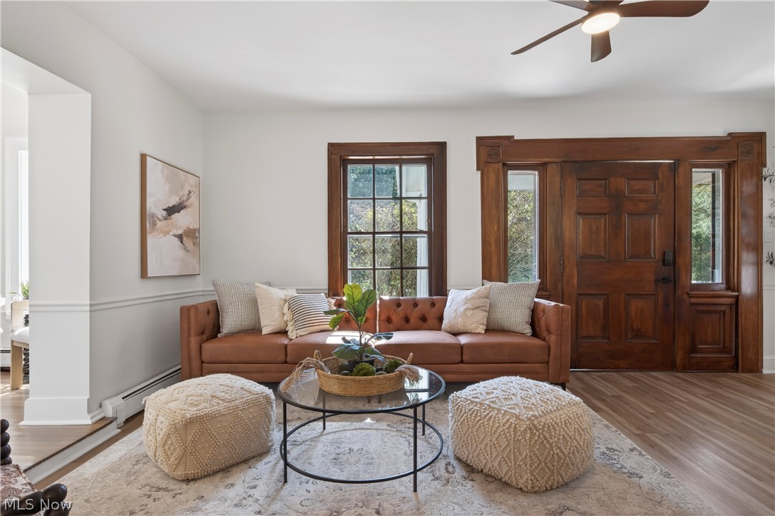 14939 Caves Road Novelty, OH 44072 - Photo 6 of 42 Living room featuring wood finished floors, baseboard heating, and a ceiling fan
