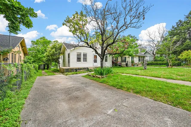 a front view of house with yard and green space