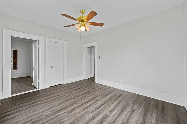 an empty room with wooden floor and window