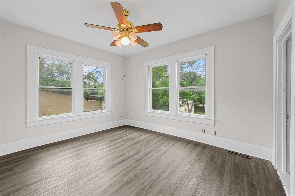 520 Brooks Avenue Dallas, TX 75208 - Photo 15 of 22 a view of an empty room with wooden floor and a window