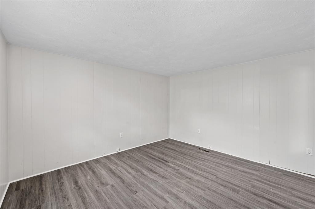 520 Brooks Avenue Dallas, TX 75208 - Photo 19 of 22 a view of an empty room with wooden floor