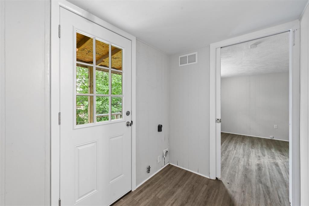 520 Brooks Avenue Dallas, TX 75208 - Photo 20 of 22 a view of an empty room with wooden floor and a window