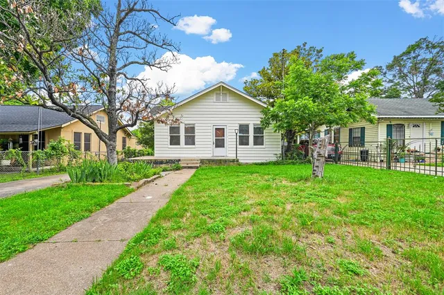 a front view of house with yard and green space