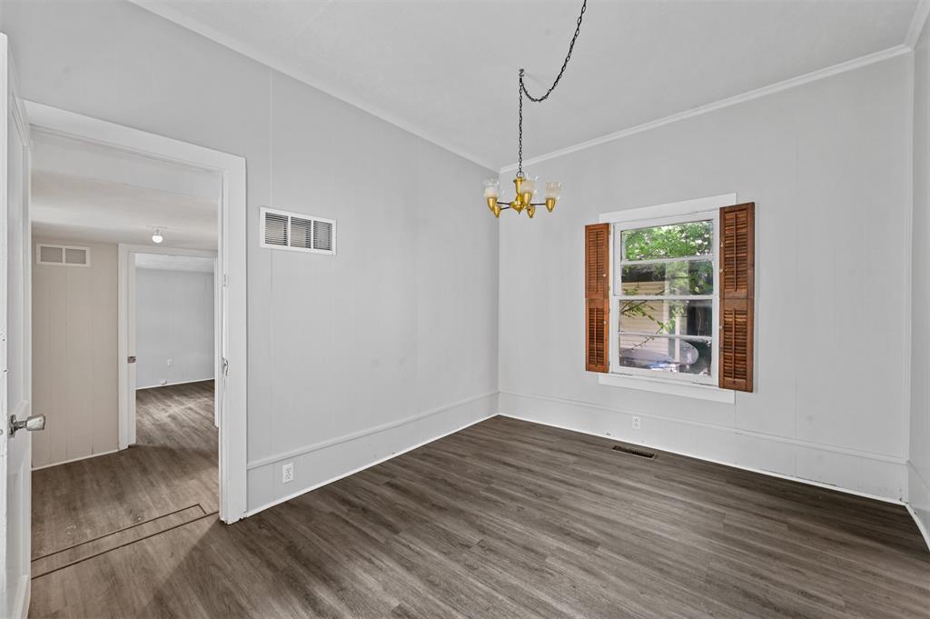 520 Brooks Avenue Dallas, TX 75208 - Photo 9 of 22 an empty room with wooden floor cabinet and windows