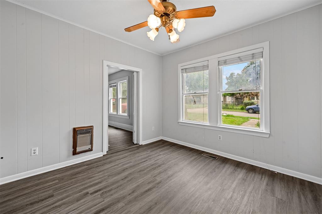 520 Brooks Avenue Dallas, TX 75208 - Photo 10 of 22 a view of an empty room with window and wooden floor