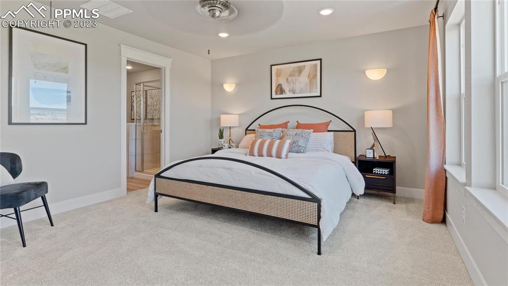 2174 Coyote Mint Drive Monument, CO 80132 - Photo 16 of 50 a bedroom with a bed and a table