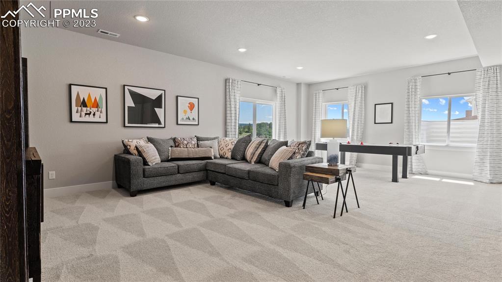 2174 Coyote Mint Drive Monument, CO 80132 - Photo 17 of 50 a living room with furniture and a lamp