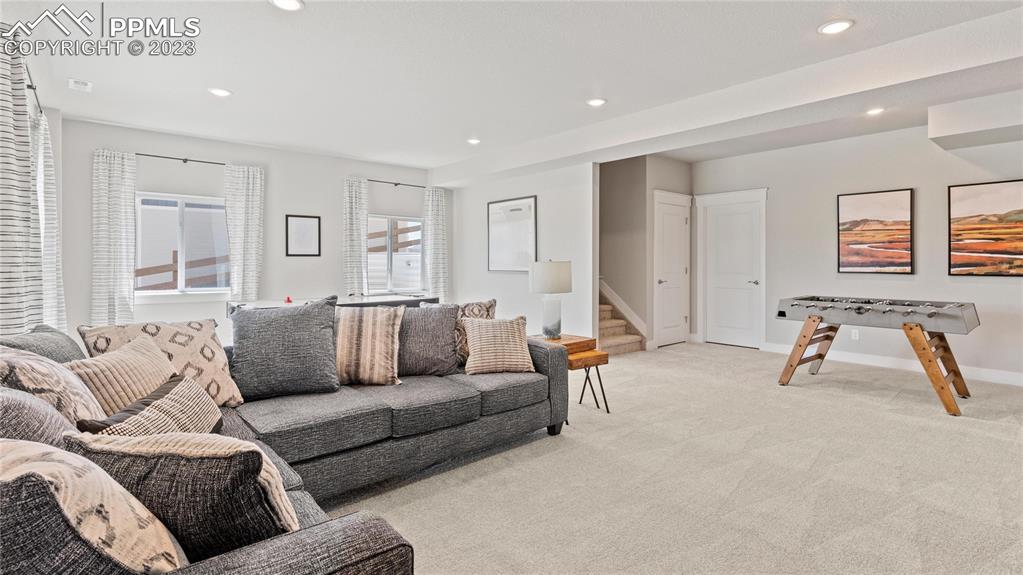 2174 Coyote Mint Drive Monument, CO 80132 - Photo 20 of 50 a living room with furniture and a large window