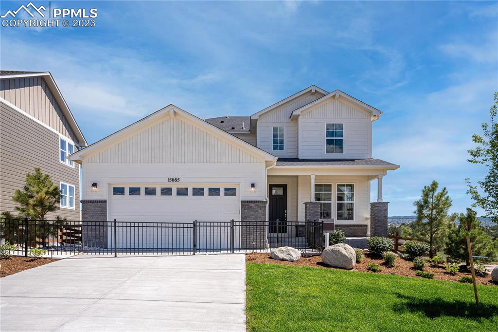 2174 Coyote Mint Drive Monument, CO 80132 - Photo 2 of 50 a front view of a house with garden