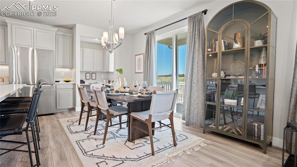 2174 Coyote Mint Drive Monument, CO 80132 - Photo 21 of 50 a view of a dining room with furniture window and wooden floor