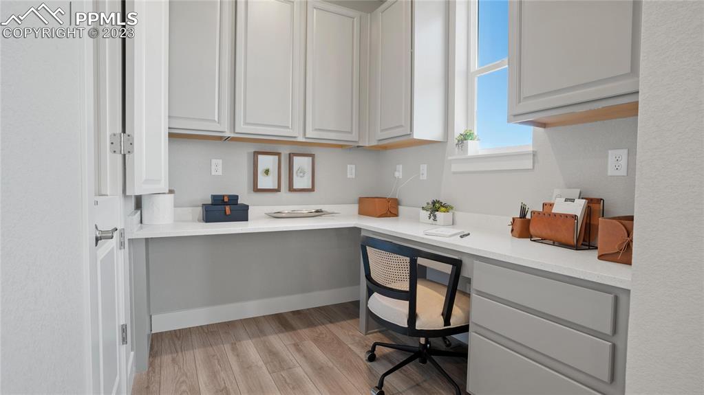 2174 Coyote Mint Drive Monument, CO 80132 - Photo 22 of 50 a kitchen with white cabinets and appliances