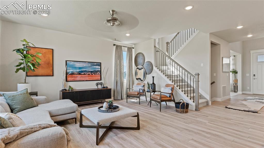 2174 Coyote Mint Drive Monument, CO 80132 - Photo 33 of 50 a living room with furniture and wooden floor