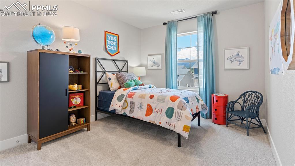 2174 Coyote Mint Drive Monument, CO 80132 - Photo 36 of 50 a bedroom with bed and a window