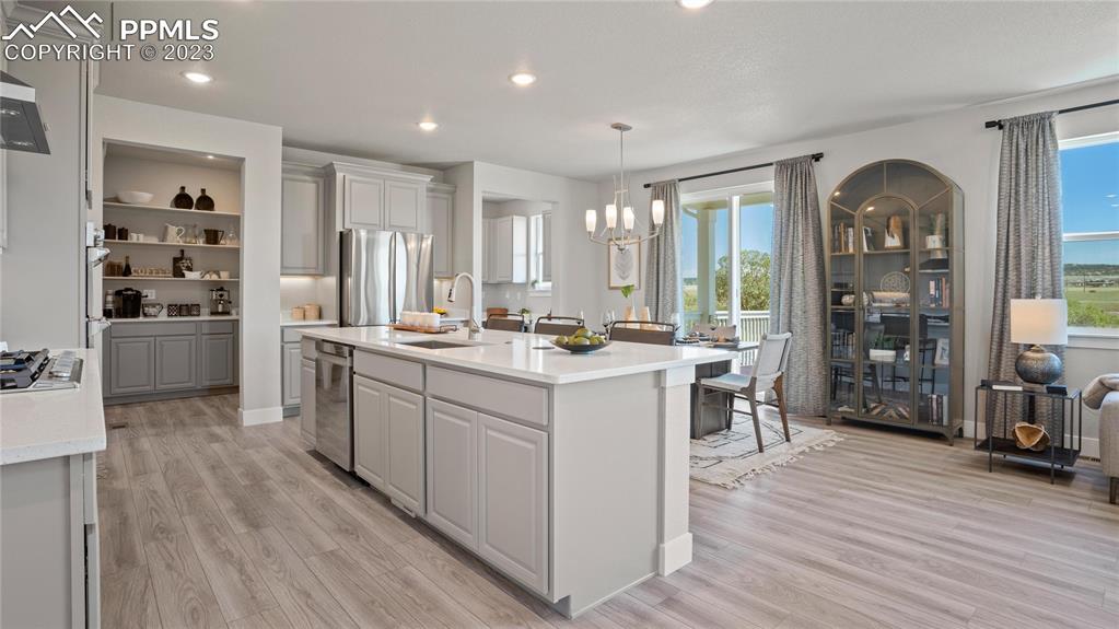 2174 Coyote Mint Drive Monument, CO 80132 - Photo 38 of 50 a kitchen with counter top space and wooden floor