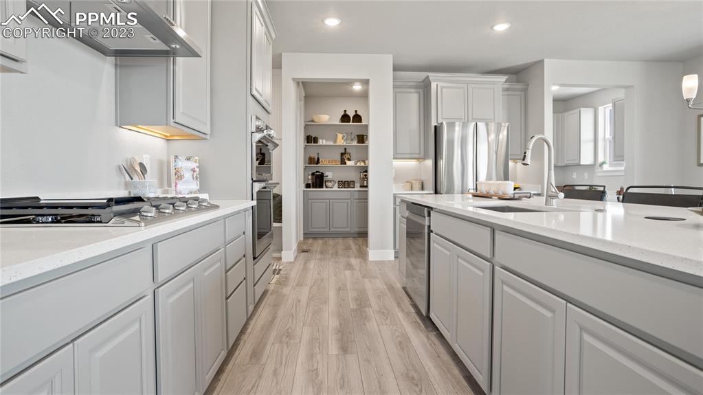 2174 Coyote Mint Drive Monument, CO 80132 - Photo 39 of 50 a kitchen with a sink stove and cabinets