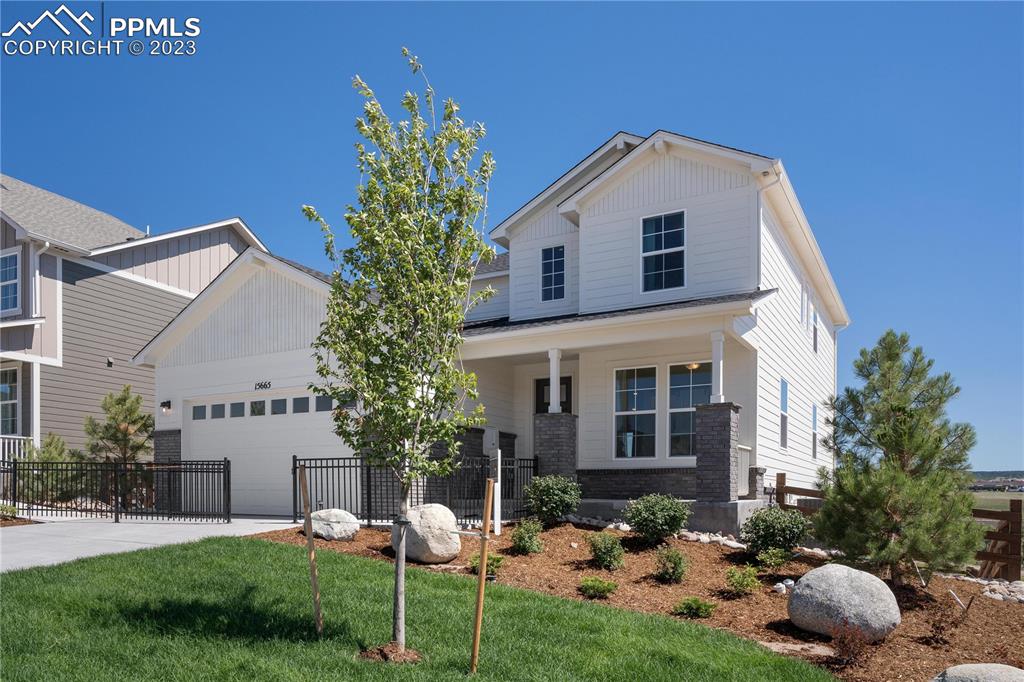 2174 Coyote Mint Drive Monument, CO 80132 - Photo 4 of 50 a front view of a house with a yard