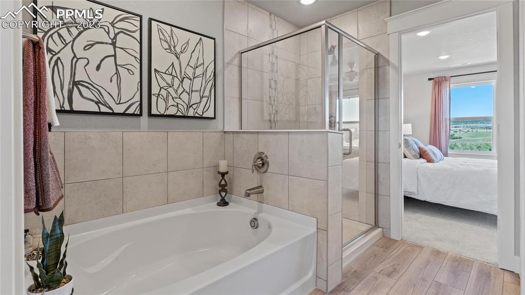 2174 Coyote Mint Drive Monument, CO 80132 - Photo 43 of 50 a bathroom with a bathtub and a shower